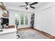 Bright bedroom features an open closet, a window with tree views, and hardwood floors at 433 W 8Th Street St, Charlotte, NC 28202