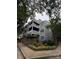 An exterior view of a multi-level building featuring gray siding, white railings, and a well-maintained landscape at 433 W 8Th Street St, Charlotte, NC 28202