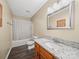 Bathroom featuring a vanity with a granite countertop, a well-lit mirror, and a shower-tub combo at 471 Hillandale Ne St, Concord, NC 28025