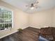 Bedroom with ceiling fan, window with blinds, and wood-look flooring at 471 Hillandale Ne St, Concord, NC 28025