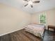 Bedroom with ceiling fan, natural light from window, and dark wood-look flooring at 471 Hillandale Ne St, Concord, NC 28025