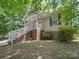 Charming home featuring a covered front porch, white railings, and green shutters at 471 Hillandale Ne St, Concord, NC 28025