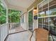 Charming front porch with a cozy chair, offering a relaxing view of the surrounding greenery at 471 Hillandale Ne St, Concord, NC 28025