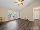 Living room with vaulted ceilings, wood-look floors, and large windows for natural light at 471 Hillandale Ne St, Concord, NC 28025