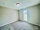 Bedroom featuring neutral carpet and trim with a single window for natural light at 5800 Silver Eagle Dr, Charlotte, NC 28214