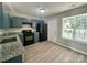 Updated kitchen with granite counters, black appliances, and wood-look flooring at 5800 Silver Eagle Dr, Charlotte, NC 28214
