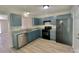 Kitchen with stainless steel appliances, blue cabinets, and laminate countertops at 5800 Silver Eagle Dr, Charlotte, NC 28214