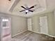 Spacious bedroom with plush carpet, recessed ceiling, fan, and ensuite bathroom at 5800 Silver Eagle Dr, Charlotte, NC 28214