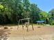 Community playground showcasing swings, climbing rocks, and a covered picnic shelter amidst lush trees at 5800 Silver Eagle Dr, Charlotte, NC 28214
