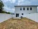 View of the backyard with a sliding door and a newly installed white vinyl fence at 619 Billingsley Rd, Charlotte, NC 28211