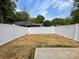Wide view of a newly fenced in backyard with a concrete patio at 619 Billingsley Rd, Charlotte, NC 28211