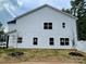 Side view of a two-story home with white vinyl siding and mulched landscaping at 619 Billingsley Rd, Charlotte, NC 28211
