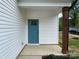 Inviting entry to this new home featuring a modern blue door and craftsman details at 619 Billingsley Rd, Charlotte, NC 28211
