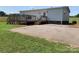 View of the home's spacious back deck and paved area, offering ample space for outdoor relaxation and entertainment at 6219 Heavner Rd, Vale, NC 28168