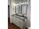 Bathroom featuring double sinks with modern black fixtures and granite countertops at 6219 Heavner Rd, Vale, NC 28168