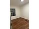 This bedroom features wood floors and a window allowing for plenty of natural light at 6219 Heavner Rd, Vale, NC 28168