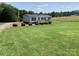 Charming home with a well-manicured lawn, a front porch, and a rustic storage building at 6219 Heavner Rd, Vale, NC 28168
