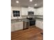 Eat-in kitchen featuring stainless steel appliances and white cabinets at 6219 Heavner Rd, Vale, NC 28168