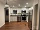 Eat-in kitchen featuring stainless steel appliances and white cabinets at 6219 Heavner Rd, Vale, NC 28168