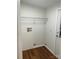 Laundry room with wood-style flooring and ample space for machines and storage at 6219 Heavner Rd, Vale, NC 28168
