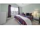 Well-lit bedroom featuring a ceiling fan, neutral carpet, and a large window at 635 Brickdust Ct, Fort Mill, SC 29708