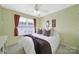 Comfortable bedroom with a ceiling fan, large window, and neutral decor at 635 Brickdust Ct, Fort Mill, SC 29708