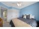 Bright bedroom featuring a ceiling fan, closet space and blue accent wall at 635 Brickdust Ct, Fort Mill, SC 29708
