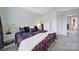 Bright bedroom with neutral carpet, a ceiling fan, and a large window at 635 Brickdust Ct, Fort Mill, SC 29708