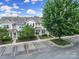 A charming two-story townhome boasts beautiful landscaping and a well-maintained parking area, perfect for suburban living at 635 Brickdust Ct, Fort Mill, SC 29708