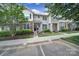 Charming two-story townhome with stone accents, manicured front yard, and inviting entrance with a black front door at 635 Brickdust Ct, Fort Mill, SC 29708