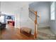 Entryway with hardwood floors, staircase, and a view into the living room featuring a cozy fireplace at 635 Brickdust Ct, Fort Mill, SC 29708