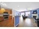 Open floor plan featuring a kitchen, dining area, and living room with hardwood floors and fireplace at 635 Brickdust Ct, Fort Mill, SC 29708