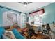 Bright office featuring barn door, hardwood floors, and cheerful blue walls near the stairs at 635 Brickdust Ct, Fort Mill, SC 29708