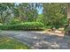 Spacious backyard with patio area surrounded by lush landscaping and mature trees at 6434 Sardis Rd, Charlotte, NC 28270