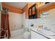 Cozy bathroom with tiled walls, black medicine cabinet, and shower-tub combo at 6434 Sardis Rd, Charlotte, NC 28270