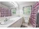 Well-lit bathroom with double vanity and tiled floors at 6434 Sardis Rd, Charlotte, NC 28270