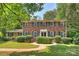 Charming two-story brick home featuring mature landscaping and black window shutters at 6434 Sardis Rd, Charlotte, NC 28270