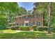 Charming two-story brick home featuring mature landscaping and black window shutters at 6434 Sardis Rd, Charlotte, NC 28270