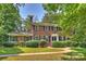 Charming two-story brick home featuring mature landscaping and black window shutters at 6434 Sardis Rd, Charlotte, NC 28270