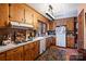 Well-lit kitchen with wood cabinets and white appliances, creating a warm and inviting space at 6434 Sardis Rd, Charlotte, NC 28270