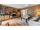 Comfortable living room features wood paneling, brick fireplace, built-in shelving, and hardwood floors at 6434 Sardis Rd, Charlotte, NC 28270