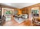Inviting living room featuring wood paneling and hardwood floors with views of adjacent rooms at 6434 Sardis Rd, Charlotte, NC 28270
