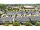 Neighborhood aerial view of townhomes near commercial buildings with walkways and lush trees at 6438 Hove Rd, Mint Hill, NC 28227