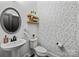 Bathroom with decorative wallpaper, round mirror, floating shelves, and modern fixtures for a stylish and functional space at 6438 Hove Rd, Mint Hill, NC 28227