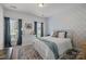 Serene bedroom with patterned accent wall, blue curtains, and natural light. A peaceful retreat at 6438 Hove Rd, Mint Hill, NC 28227