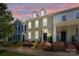 Charming townhome at dusk with landscaped front yard, brick stairs, and classic architectural details at 6438 Hove Rd, Mint Hill, NC 28227