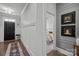 Bright hallway with hardwood floors leading to a bedroom, complemented by neutral walls and elegant decor at 6438 Hove Rd, Mint Hill, NC 28227