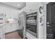 Well-lit kitchen showcases stainless steel appliances, white cabinets, and tiled backsplash at 6438 Hove Rd, Mint Hill, NC 28227
