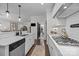 Open-concept kitchen with stainless steel appliances, gas range, and modern fixtures at 6438 Hove Rd, Mint Hill, NC 28227