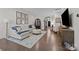 Inviting living room with hardwood floors, a large sectional sofa, and natural light at 6438 Hove Rd, Mint Hill, NC 28227